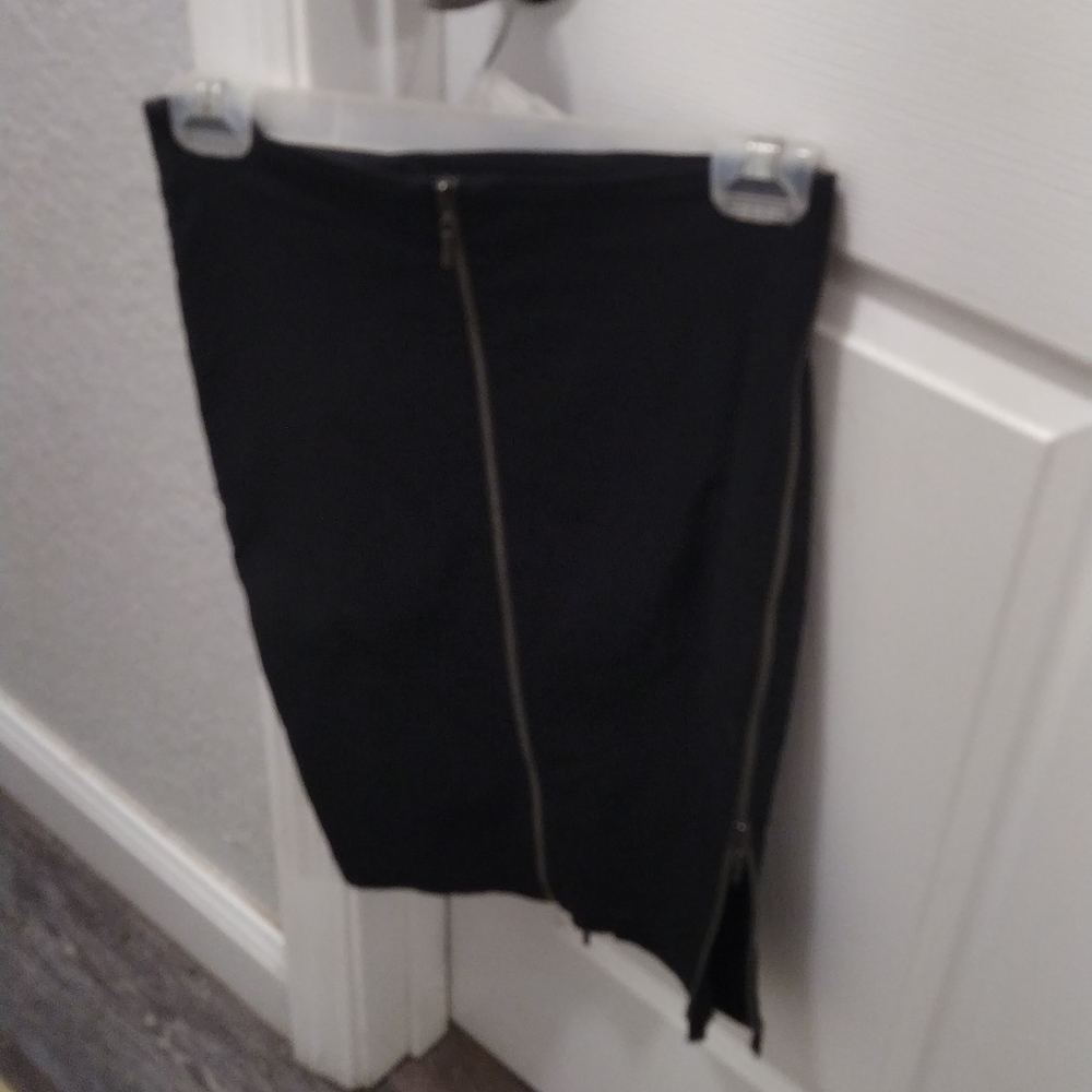 Bebe black pencil skirt. zipper on both legs. very tight fitting size 0